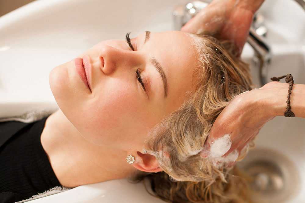 Woman getting her hair washed at a salon.